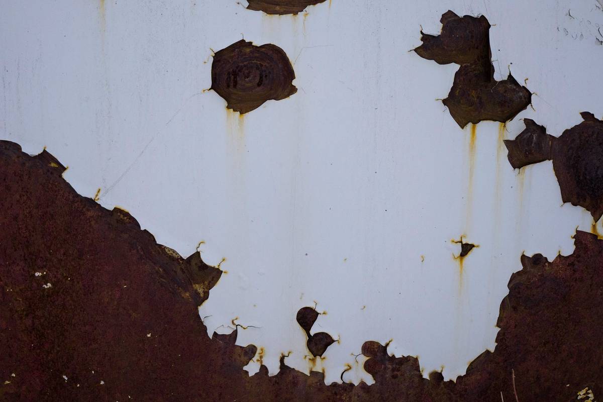 eco pro tec rust stain remover being applied to a rusty bathroom faucet with before-and-after results visible